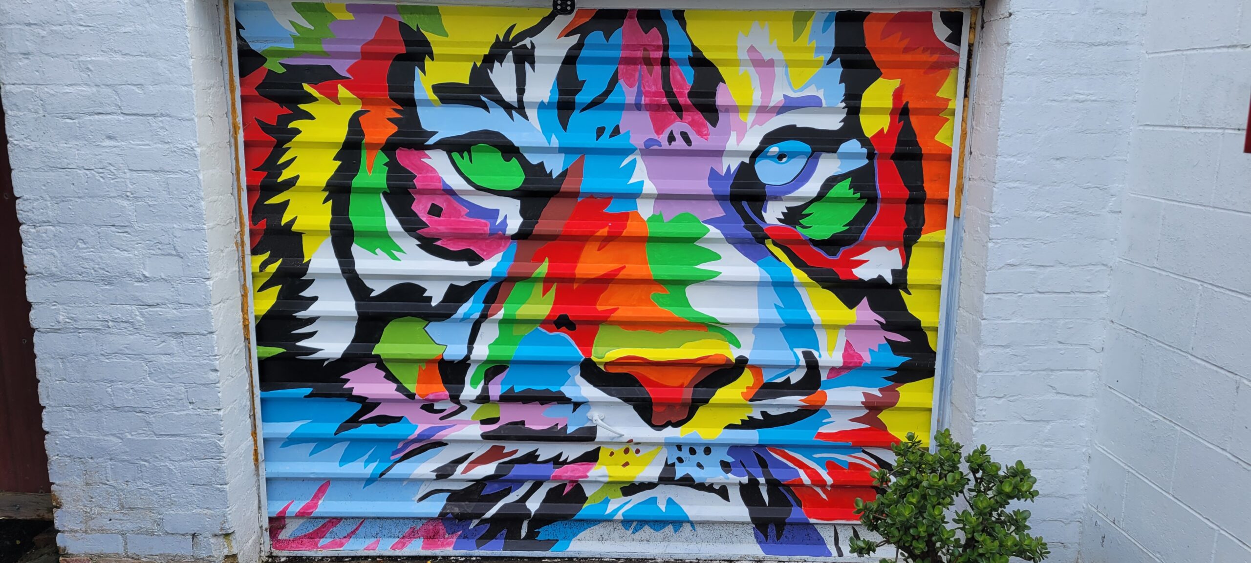 a painting of a tiger on cattery garage door